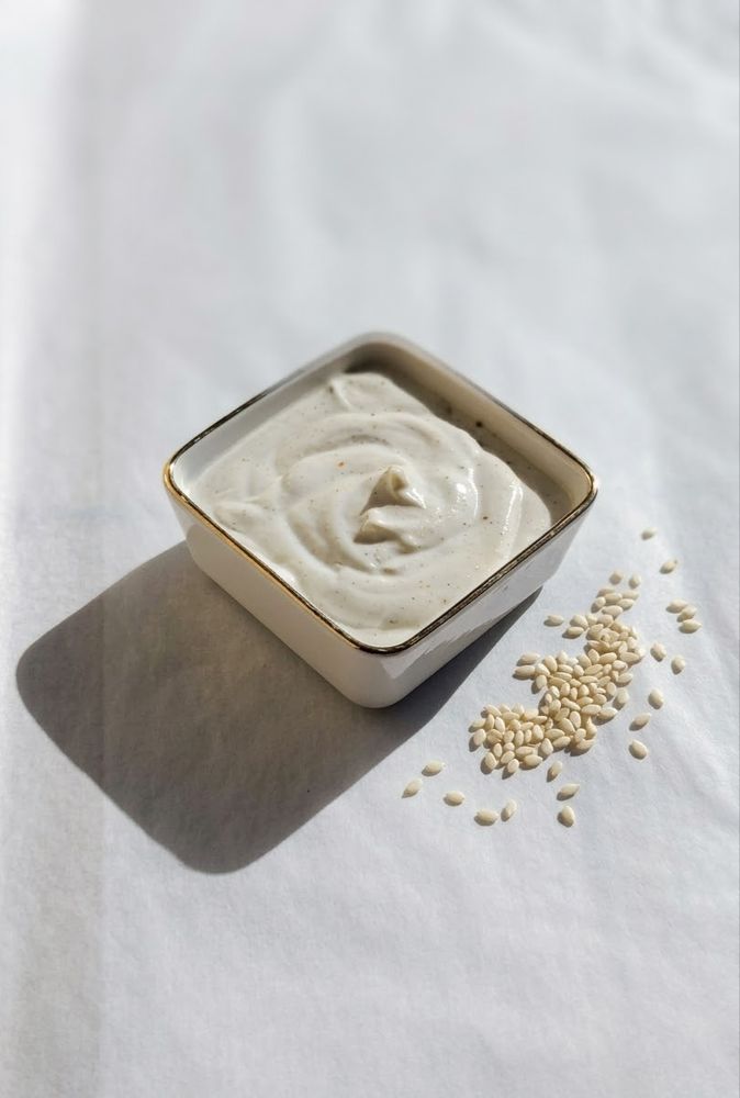A bowl of sesame sauce with sesame seeds